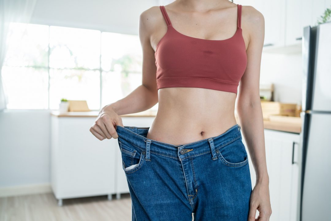 close up of woman feel happy after lose weight for health in house